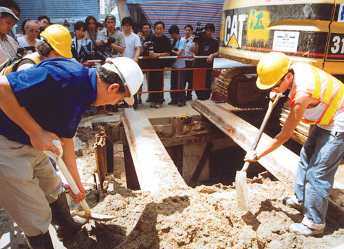 Antiquities and Monuments Office staff conduct an on-site investigation after relics are uncovered at a work site at the junction of Soy Street and Tung Choi Street, Mong Kok.