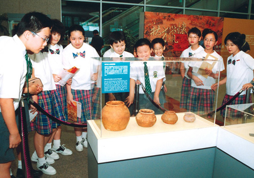 學生對在旺角的工程工地發現的陶製文物深感興趣。