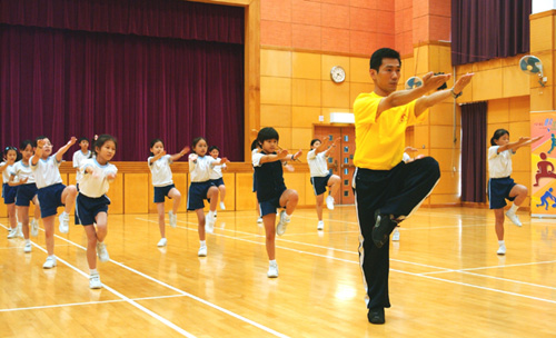 Students learning wushu through the Outreach Coaching Programme.