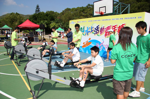 Students work out on rowing machines at a carnival organised to stimulate interest in water sports.
