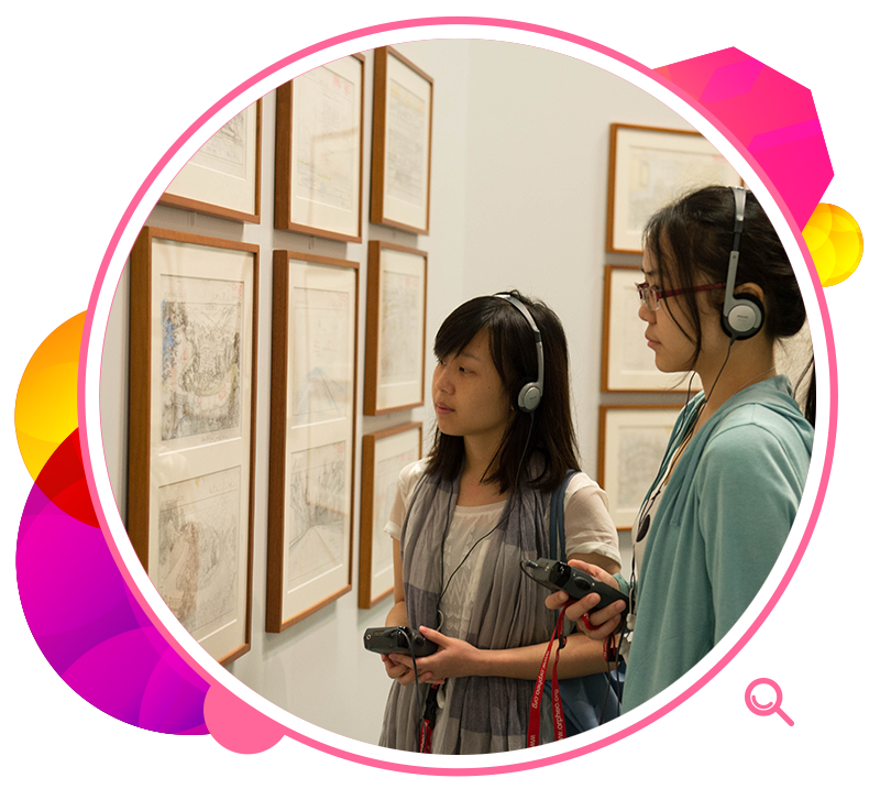 Visitors using audio guides to view exhibits at the exhibition Studio Ghibli Layout Designs: Understanding the Secrets of Takahata and Miyazaki Animation. 