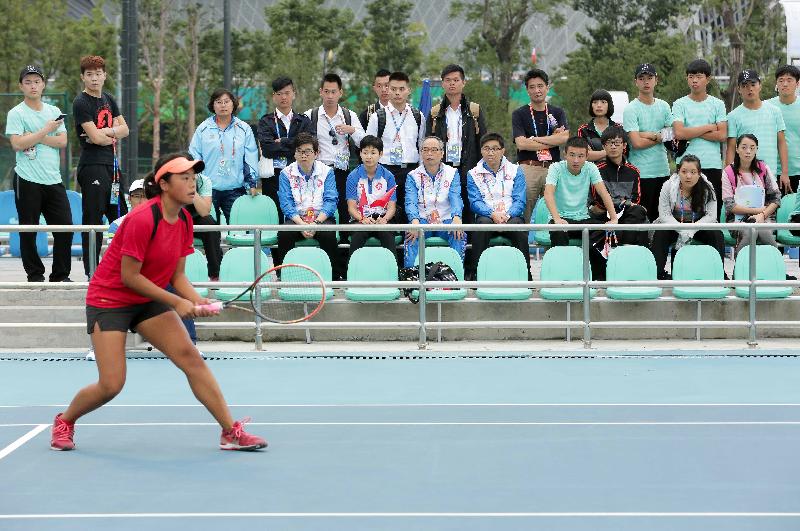 Mr Lau (front row, sixth right) watches a tennis match this afternoon.