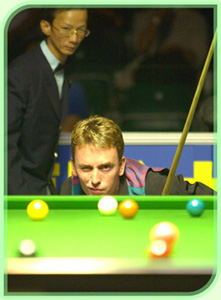 Snooker master eyes the shot.