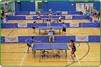 Athletes compete energetically during a table tennis game at the 4th Hong Kong Games.