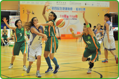 Basketball players at full stretch in a match played at the Hong Kong Games.