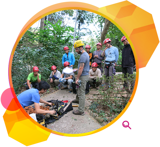 Staff carrying out an equipment check in a tree-climbing course.