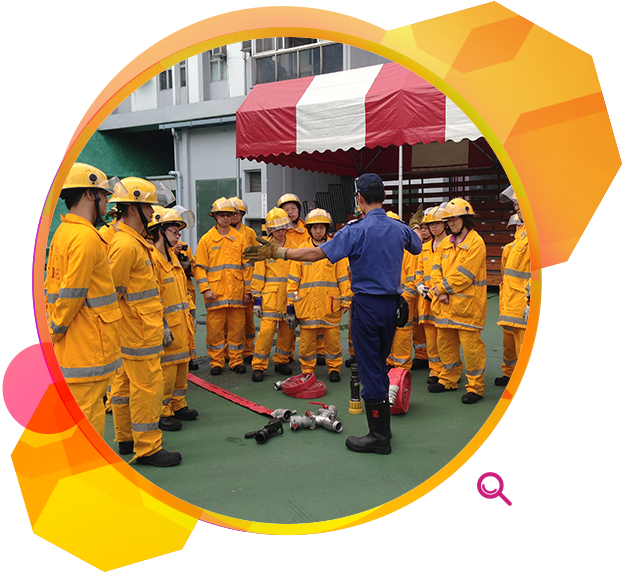 Staff in a fire prevention training course being instructed on the proper way to use equipment.