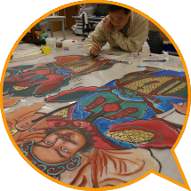 A conservator tracing the fading images of door gods on the doors of the Tat Tak Communal Hall.