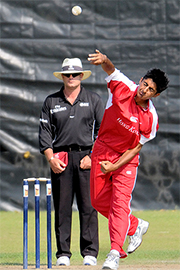 The Hong Kong cricket athlete strongly bowled the ball during the competition. The left corner of the photo is a wicket