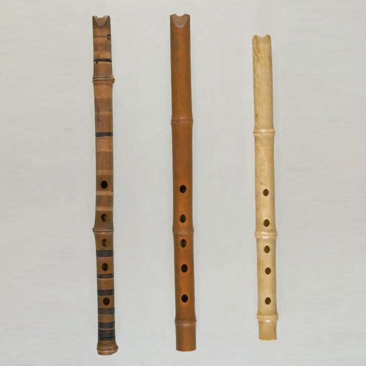 Shakuhachi with birch tree bark (left), shakuhachi (middle) and stone shakuhachi (right)